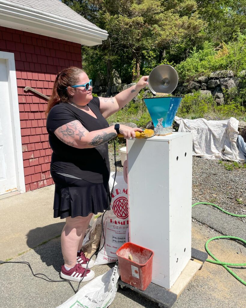 Erin grinding grain for the steinbeer